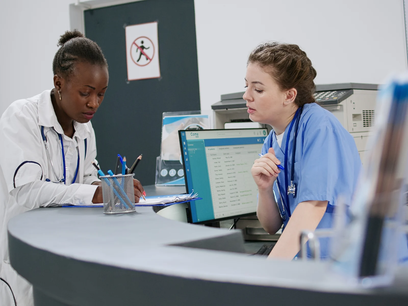 Clinic staff working at a reception desk